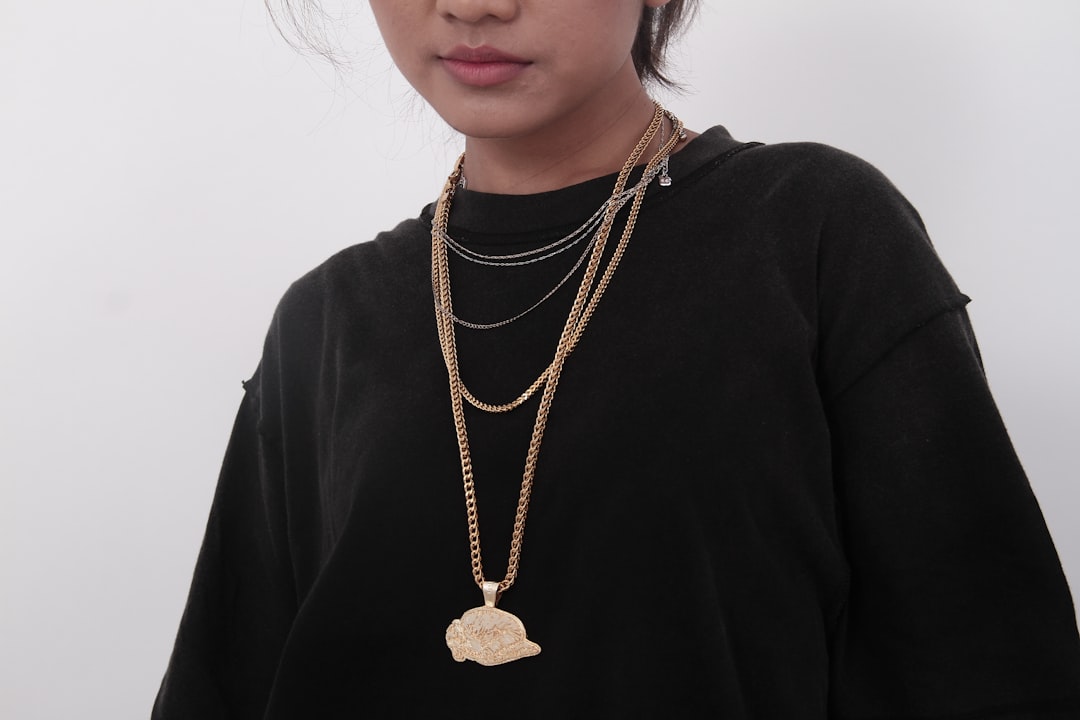A stylish black and gold outfit displayed on a mannequin or model, showcasing a balanced and elegant look.